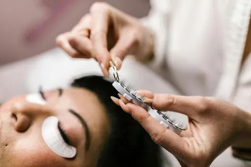 Close-up of professional eyelash extension bonding process with premium cashmere lashes