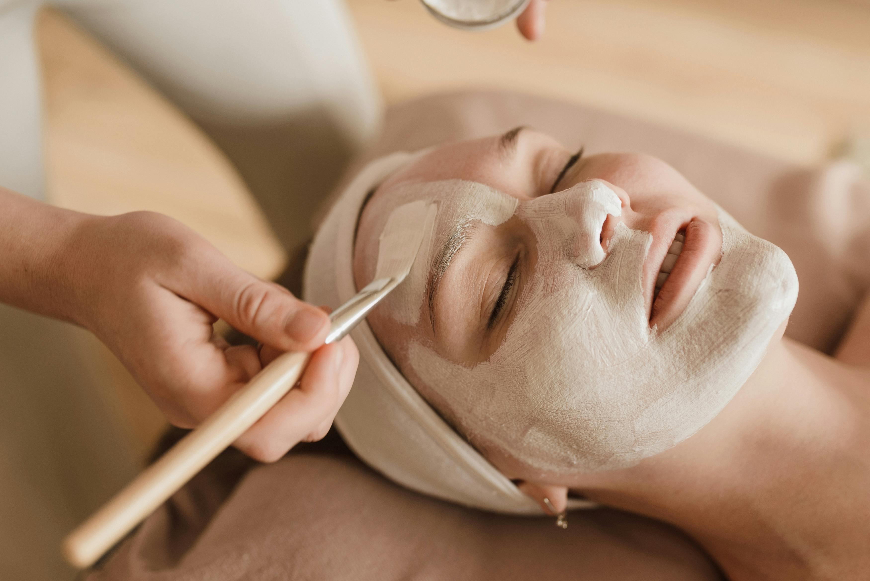 Professional luxury facial treatment — mask application with brush at Jinny's Eyelash and Beauty Studio