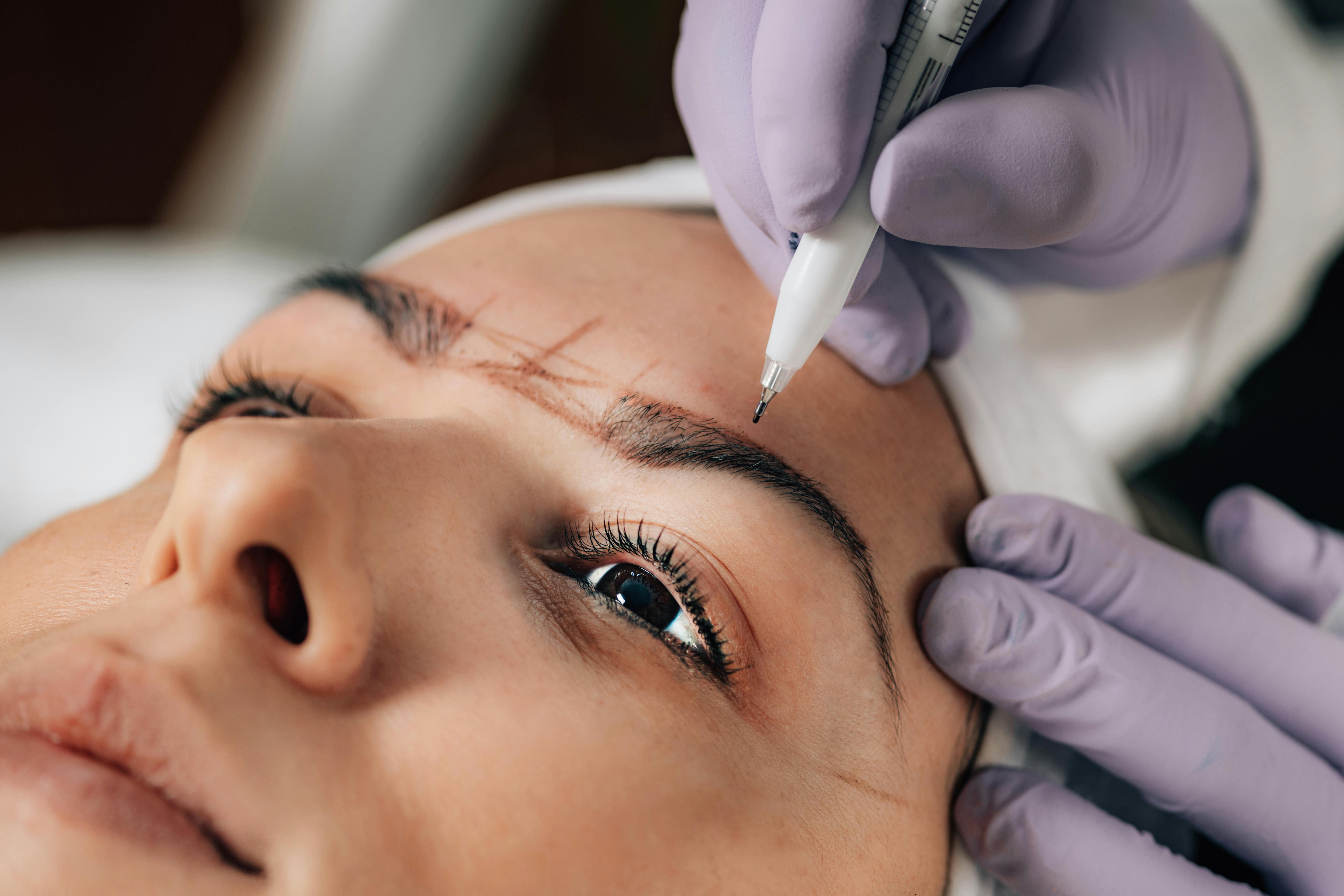 Permanent makeup eyebrow treatment in progress at Jinny's Beauty Studio