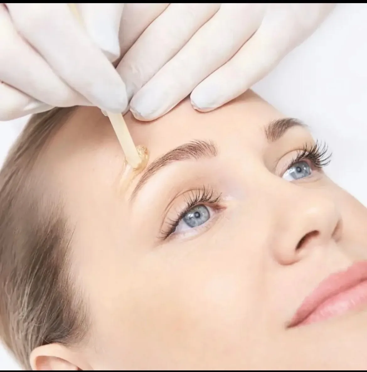 Precision eyebrow waxing with sugar wax — gentle, hygienic technique at Jinny's Beauty Studio